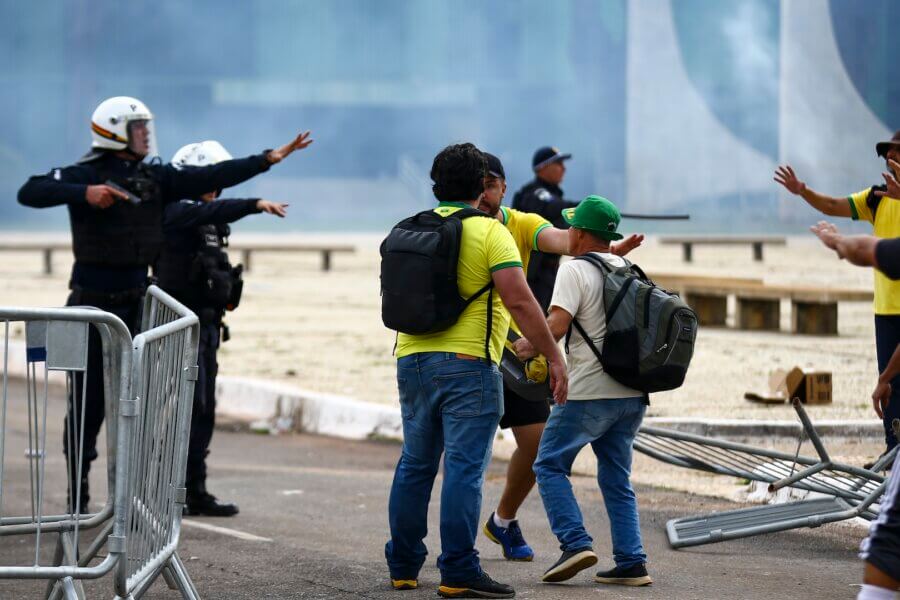 Golpistas e profissionais de segurança durante os atos do 8 de Janeiro